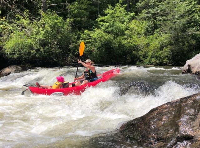 woman and child rafting along the waves on the Chattooga River in Long Creek South Carolina